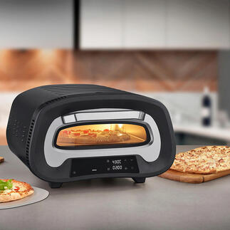 Four à pizza à 430 °C sur un plan de travail, entouré d'ingrédients