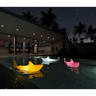 Luminaires en forme de requin colorés flottant dans la piscine la nuit