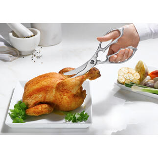 Ciseaux de cuisine et de volaille 2-en-1 coupant un poulet sur une assiette.