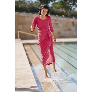 Femme en robe rose près de la piscine