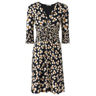 Vue de face d'une robe en jersey noir et blanc avec des fleurs abstraites et une taille élastique.