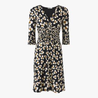 Vue de face d'une robe en jersey noir et blanc avec des fleurs abstraites et une taille élastique.