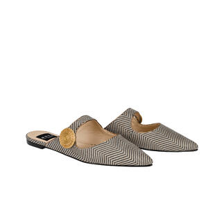Deux mules pointues en noir et blanc avec un détail décoratif.