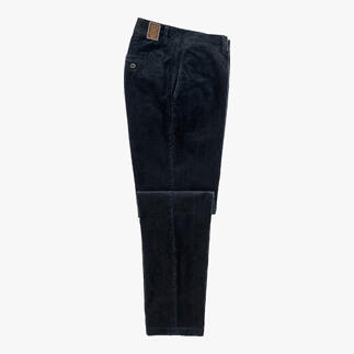 Pantalon en velours noir posé sur une table avec des poches ouvertes.