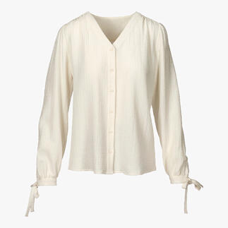 Blouse en coton-cachemire claire à manches longues et liens à nouer.