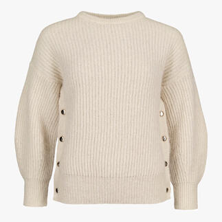 Pull beige à coupe ample avec des boutons sur les côtés.