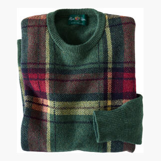 Pull tartan vert avec motif rouge-jaune, plié.