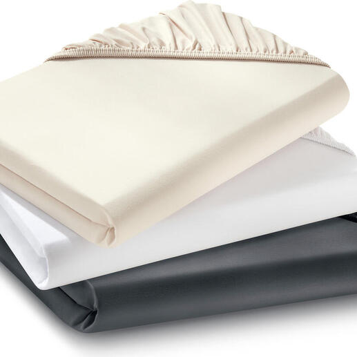 Trois draps-housses de luxe empilés.