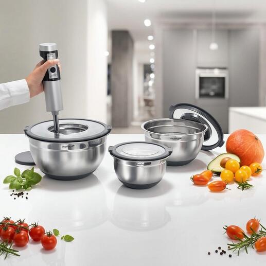 Trois bols en acier inoxydable de différentes tailles avec des ustensiles de cuisine sur un plan de travail.