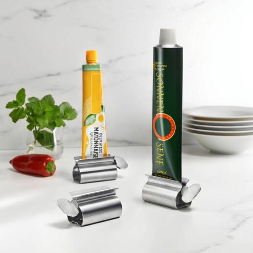 Presse-tube en acier inoxydable avec poignée XXL tenant deux tubes dans la cuisine.