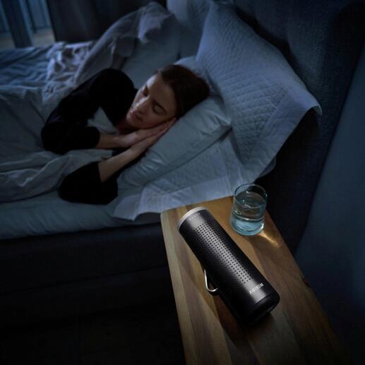 Purificateur d'air mobile 2-en-1 sur une table de nuit à côté d'une personne dormant