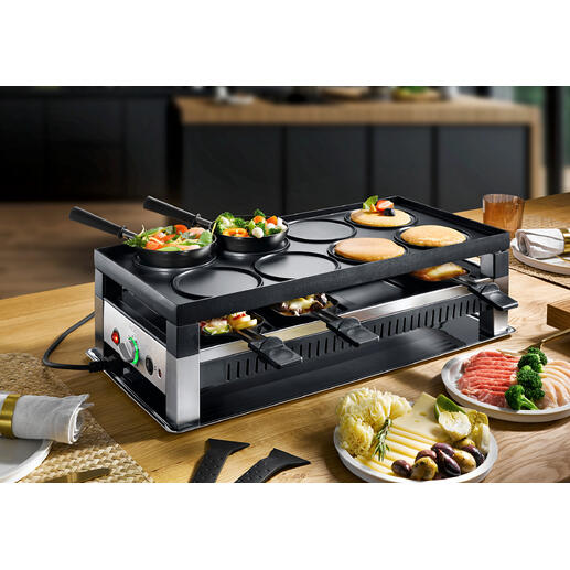 Appareil Solis raclette et fun-cooking 5-en-1 avec légumes et viandes sur la table.