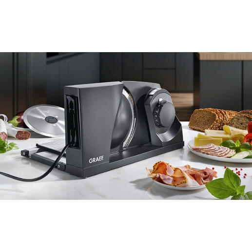 Trancheur universel ultra-compact Le trancheur universel en métal le plus compact au monde. Made in Germany. Trancheuse ultracompacte sur un plan de travail moderne.