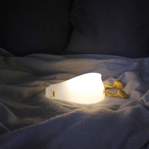 Lampe de nuit canard fatigué s'illumine sur un lit.
