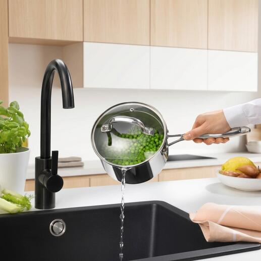 Casserole à long manche avec couvercle, de l'eau est versée dans l'évier.