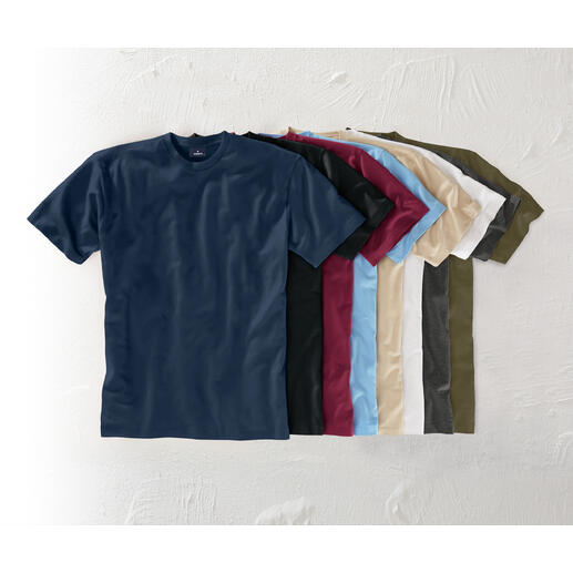 Le Ragman à 155 g Résistant et pourtant souple et léger. Opaque mais assez fin pour pouvoir être aussi porté sous une chemise. Différentes couleurs du T-shirt Ragman 155 g sur une table.