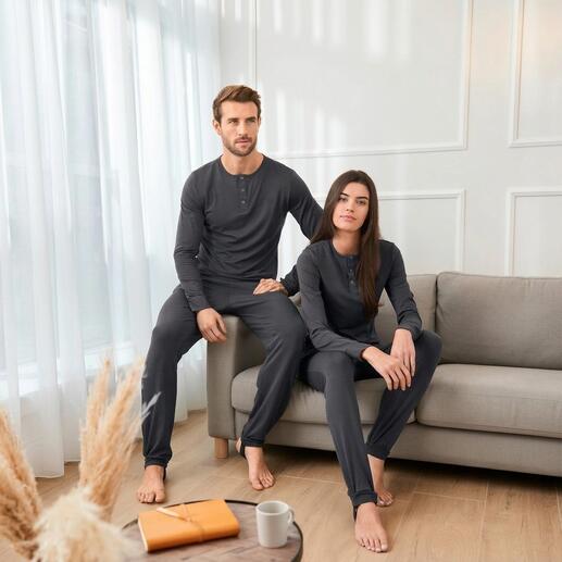 Couple en pyjamas anti-insectes grises sur un canapé.