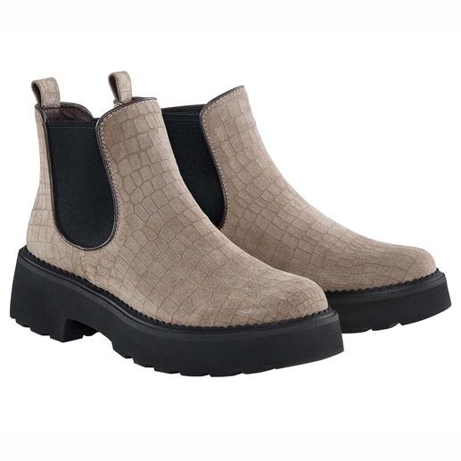Deux bottes Chelsea beiges côte à côte, avec surface structurée.
