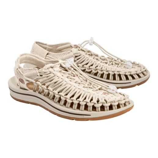 Une paire de sandales Uneek de KEEN en couleur naturelle sur fond blanc.