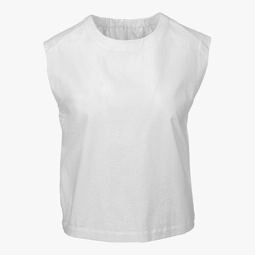 Chemisier blanc sans manches avec surface texturée.