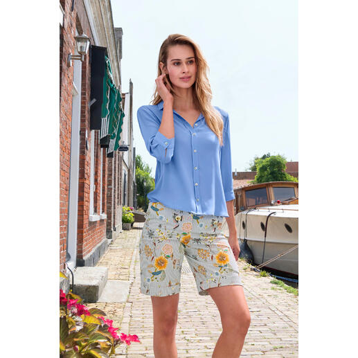 Bleu-gris Femme portant un short Bermuda Edel à motif floral dans une ville portuaire.