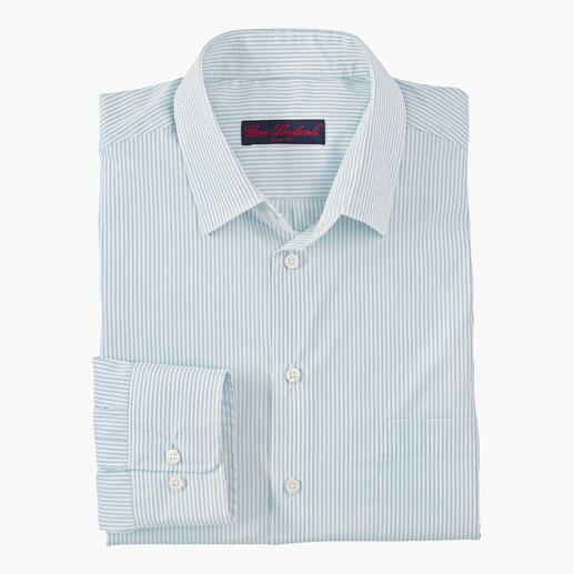 Chemise en laine mérinos et soie en bleu-écru, pliée et posée sur une table.