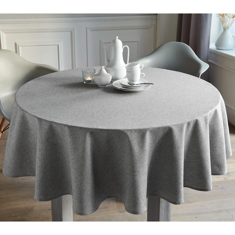 Nappe ronde en look lin grise sur une table