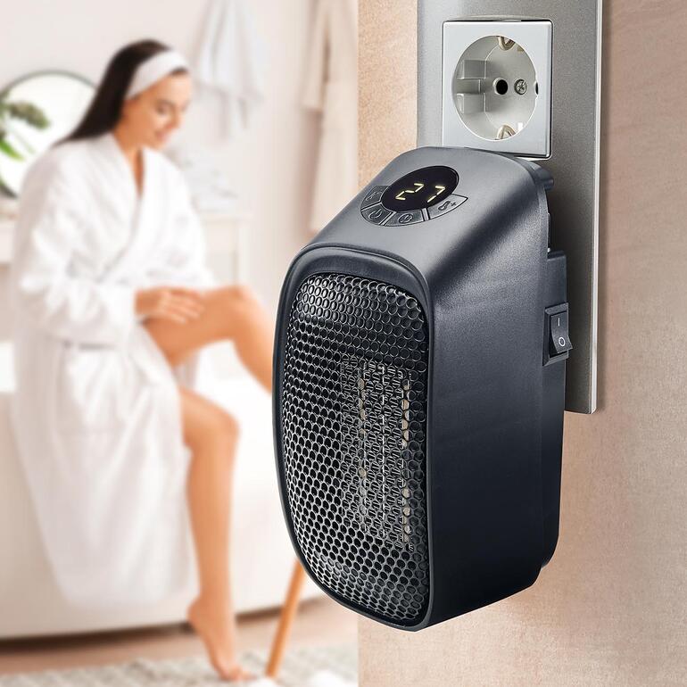 Chauffage mini-prise, branché sur une prise murale, indicateur de fonctionnement visible.