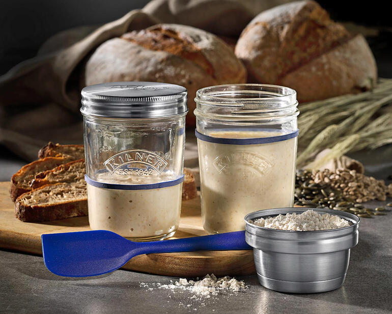 Set Kilner® de préparation de pain au levain avec bocaux et ingrédients sur une planche en bois