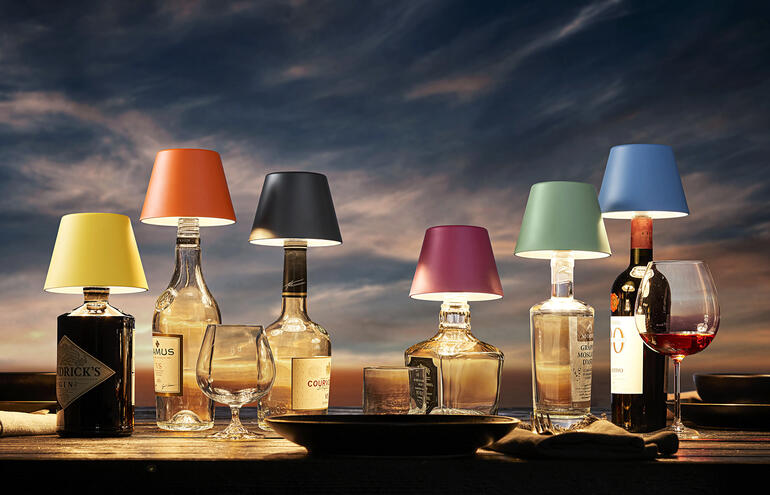 Six lampes de bouteilles LED rechargeables de différentes couleurs sur une table.