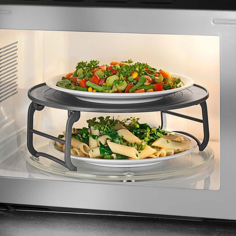 Étagère à micro-ondes dans un four à micro-ondes avec des légumes et des pâtes.