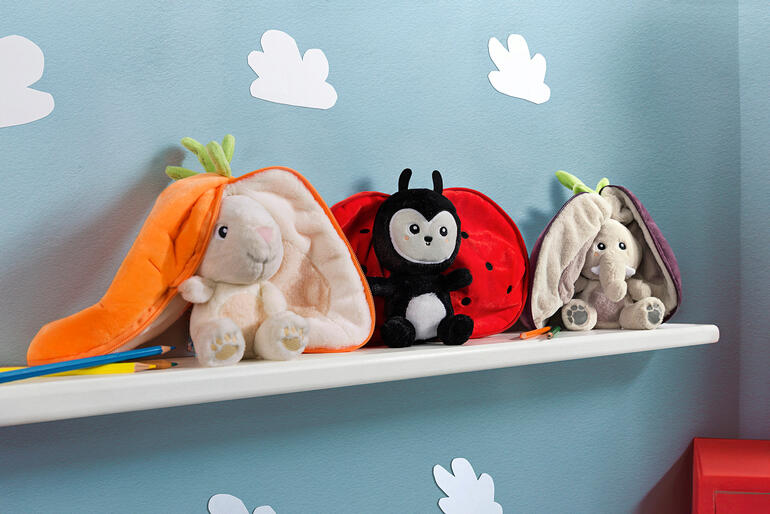 Jouet en peluche à retourner sur une étagère, carotte, coccinelle et lapin.