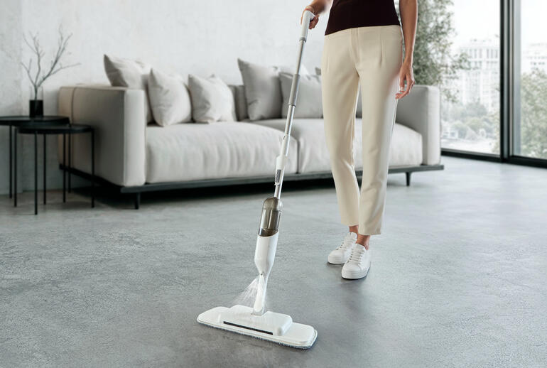 Le mop spray 3-en-1 est utilisé par une femme, le sol est vide
