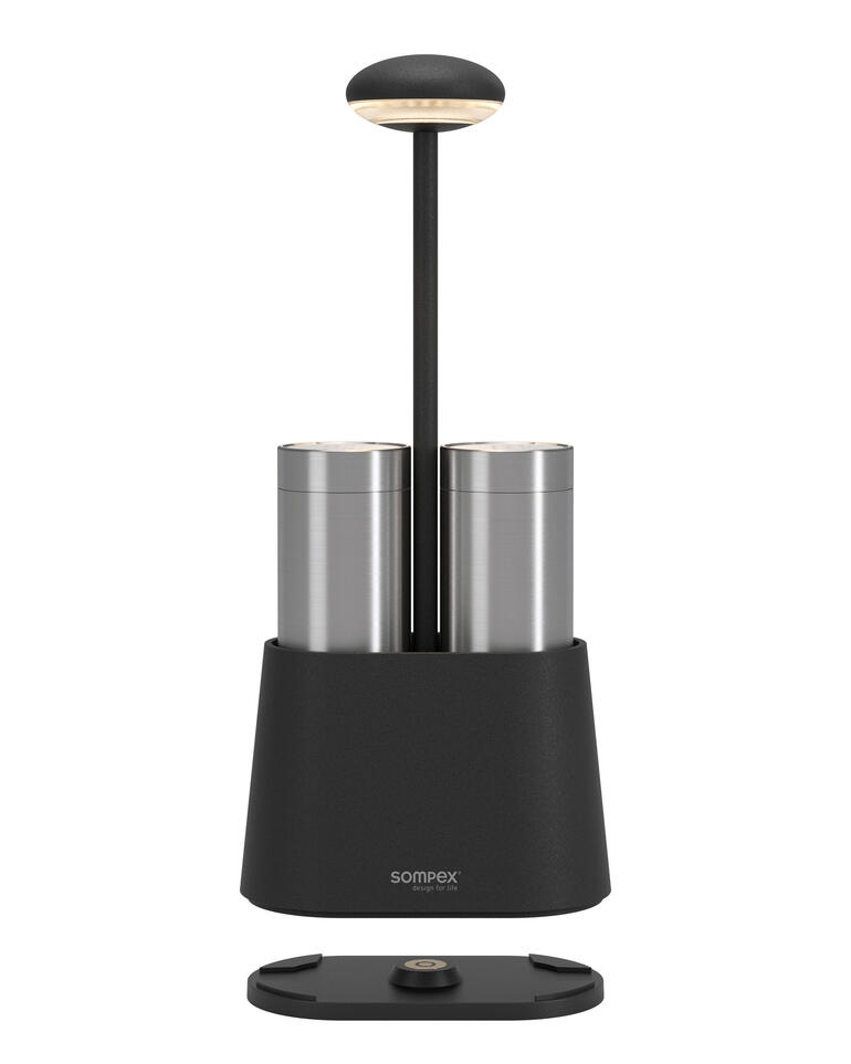 Lampe à poivre et sel noire avec deux récipients sur fond blanc.