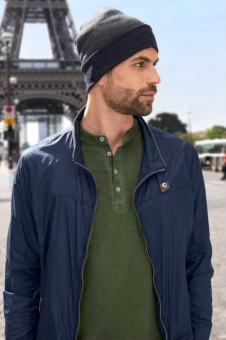 Homme en bonnet réversible gris foncé devant la Tour Eiffel.