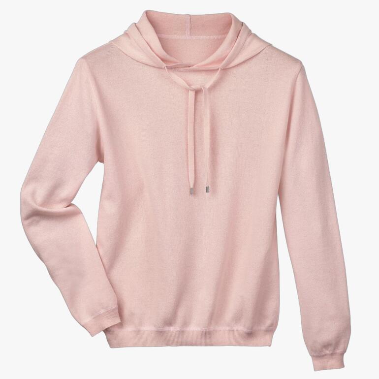 Hoodie rose en coton et cachemire sur fond blanc.