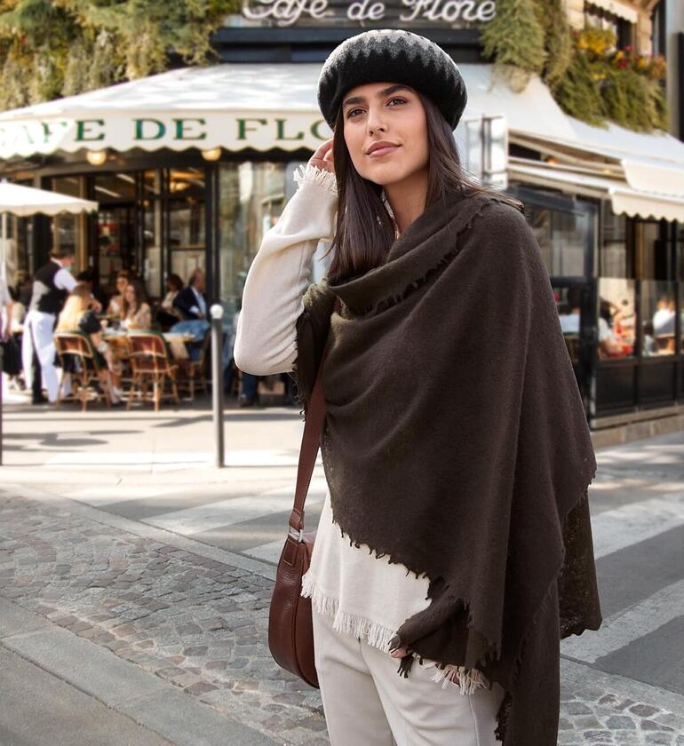 Multi Noir/Créme/Gris Gros plan d'une femme avec un pull à franges marron et un chapeau.