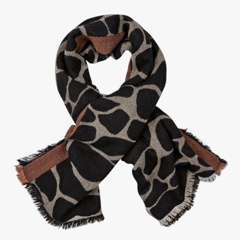 Poncho réversible avec motif de girafe en noir et beige, drapé lâchement.