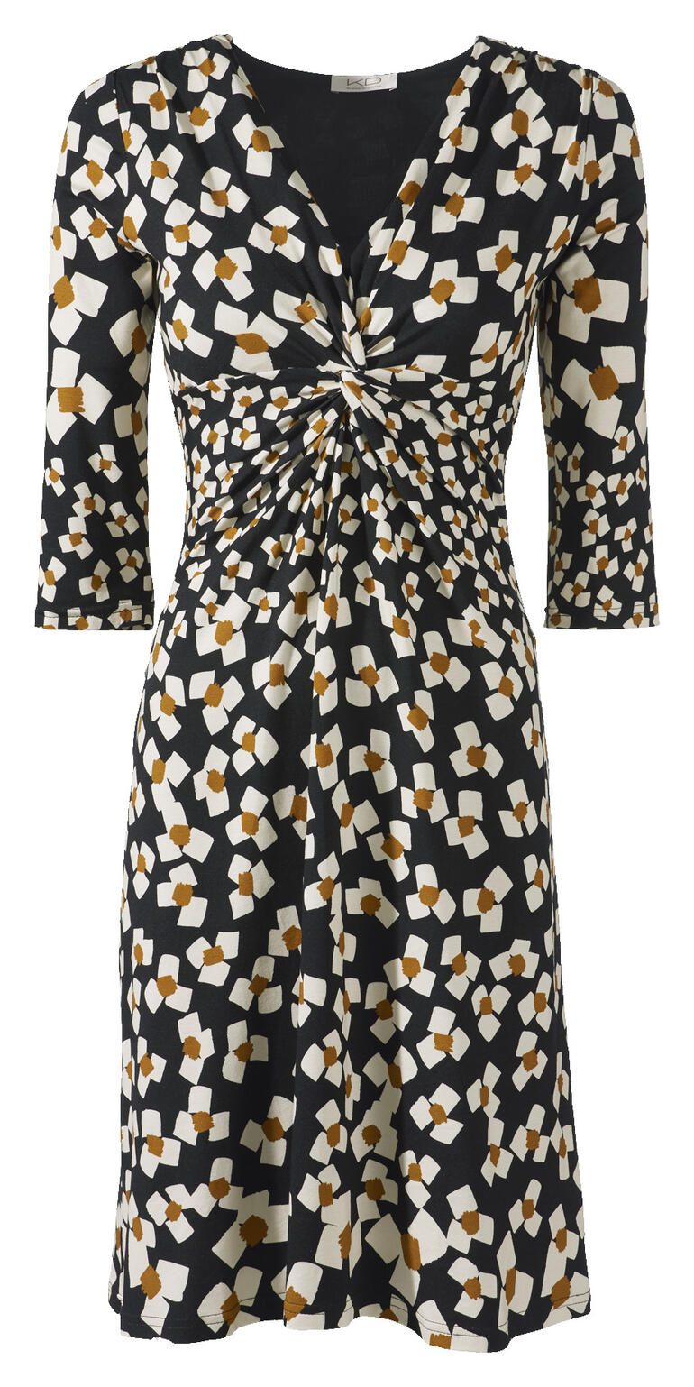 Vue de face d'une robe en jersey noir et blanc avec des fleurs abstraites et une taille élastique.