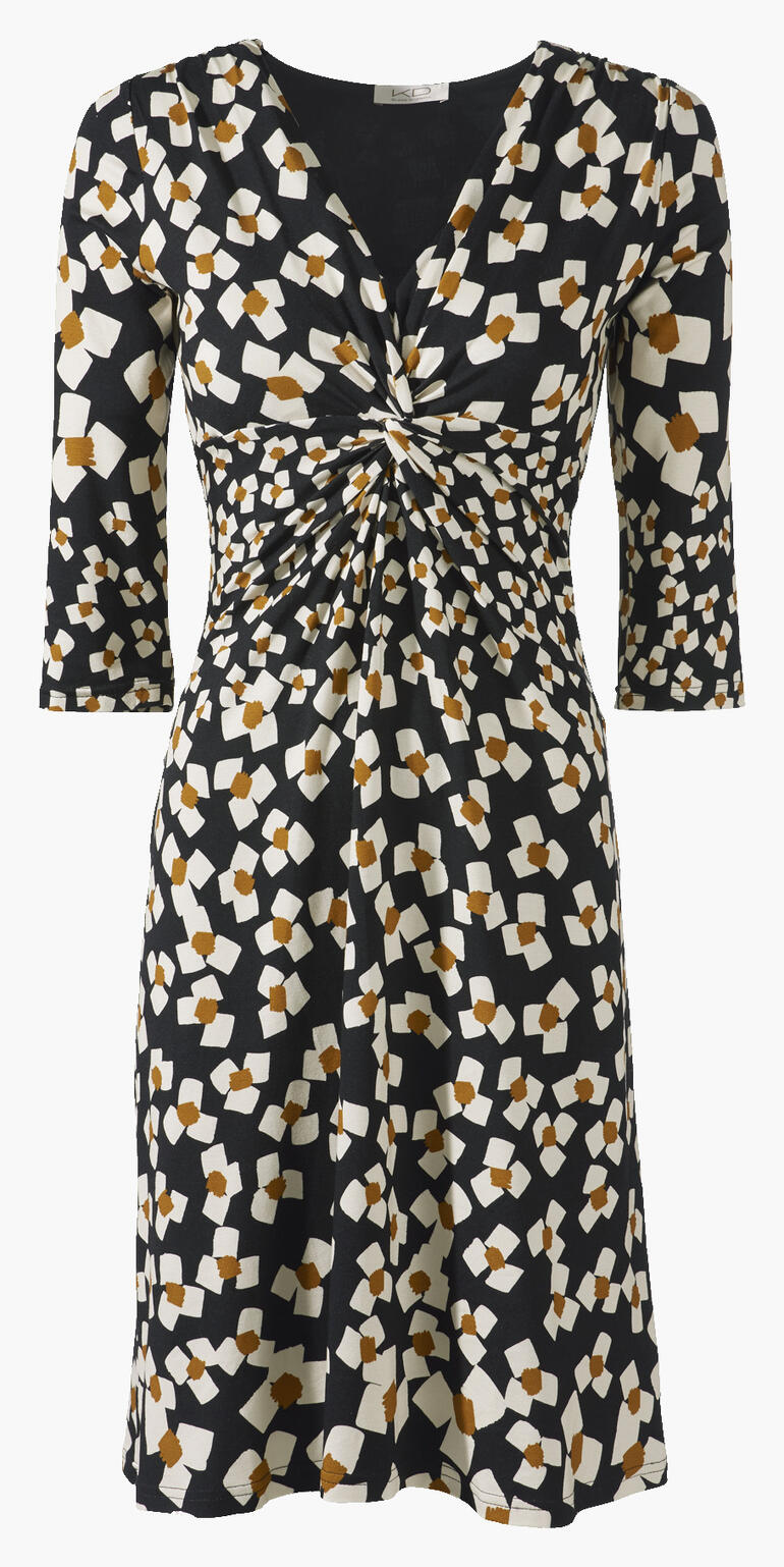 Vue de face d'une robe en jersey noir et blanc avec des fleurs abstraites et une taille élastique.