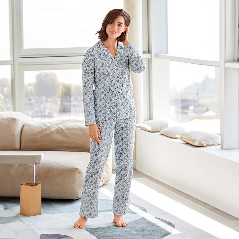Pyjama Ralph Lauren Flowers, debout devant une grande fenêtre dans une pièce confortable.