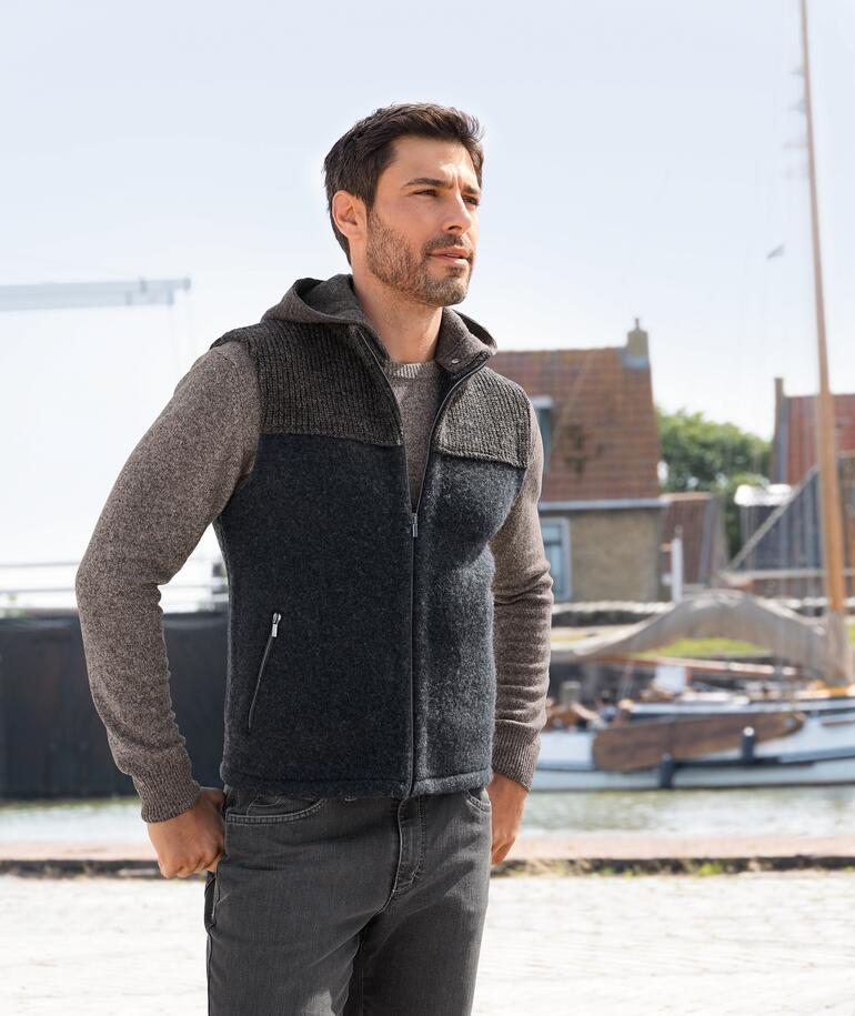 Homme dans un gilet à capuche stapf Walk, regardant sur le côté, port en arrière-plan.