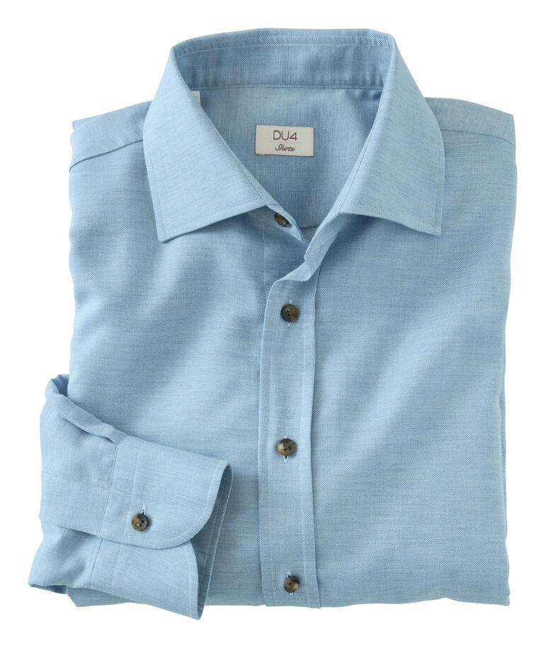 Chemise en flanelle en cachemire DU4 pliée en bleu clair sur une table.